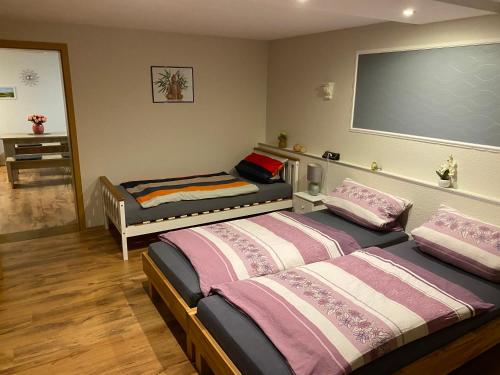 a bedroom with two beds and a projection screen at Fewo Stein in Altenbeken