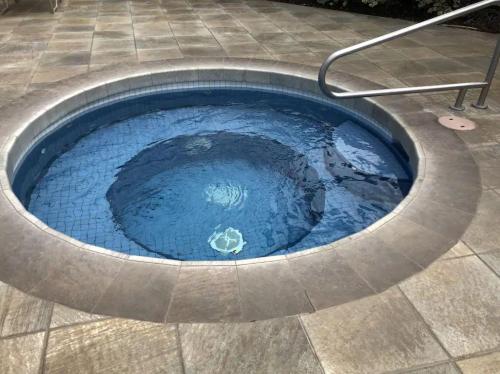 a small pool of blue water in a patio at Maui Kamaole B207 in Wailea