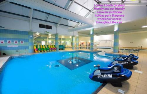 a large swimming pool with an inflatable boat in a gym at Southview holiday park skegness disabled friendly in Skegness