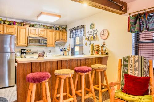 a kitchen with wooden stools and a counter top at Outdoor Hideout in Angel Fire