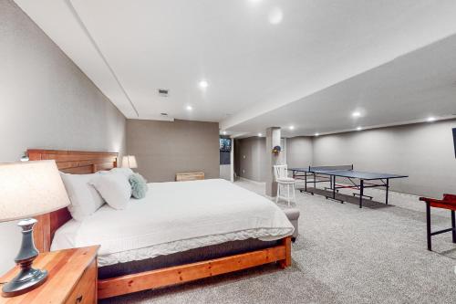 a bedroom with a bed and a ping pong table at Stone Creek Fairway in Avon