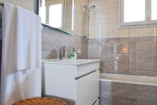 a bathroom with a sink and a toilet and a tub at Casa da Piedade, a Home in Madeira in Ponta do Sol