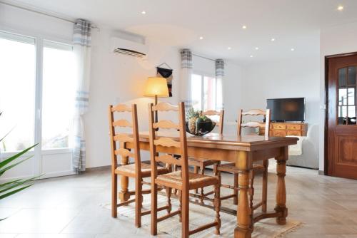 a dining room with a wooden table and chairs at Casa da Piedade, a Home in Madeira in Ponta do Sol