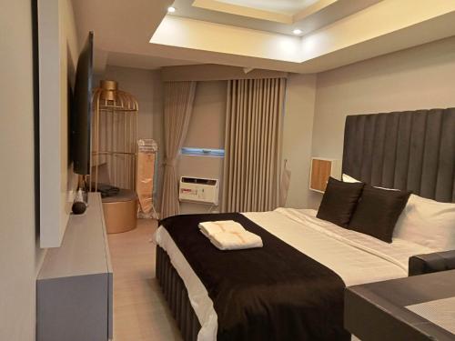 een slaapkamer met een groot bed in een kamer bij Elegant Studio with videoke at Azure North Pampanga in San Fernando
