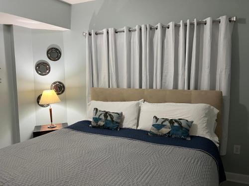 a bedroom with a large bed with two pillows at Shores of Panama Condo With Same Level Parking in Panama City Beach