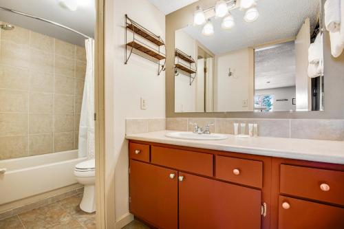 a bathroom with a sink and a toilet and a mirror at Silver Queen 7300 in Silverthorne