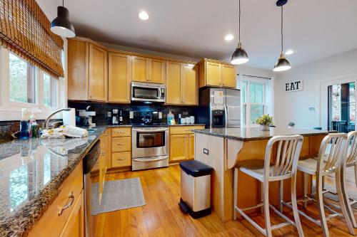 a kitchen with wooden cabinets and stainless steel appliances at 6 Fieldstone Ct in Lake Harmony