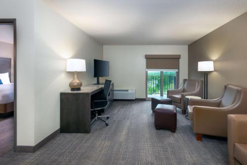 a hotel room with a bed and a desk and chairs at Ameniti Bay - Best Western Signature Collection in Sarasota