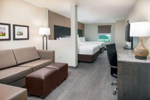a hotel room with two beds and a couch at Ameniti Bay - Best Western Signature Collection in Sarasota