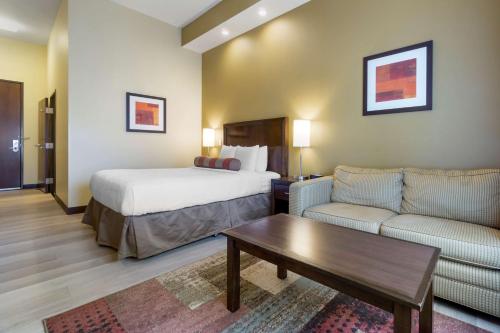 a hotel room with a bed and a couch at Best Western Plus Lacey Inn & Suites in Lacey