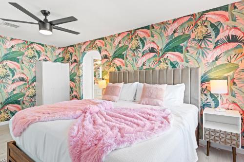 a bedroom with a pink bed with a pink blanket at La Vie en Rose Permit# 3901 in Palm Springs