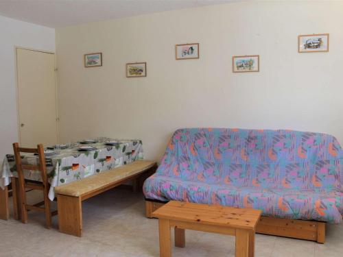 a living room with a couch and a table at Appartement Vars, 1 pièce, 6 personnes - FR-1-330B-106 in Vars