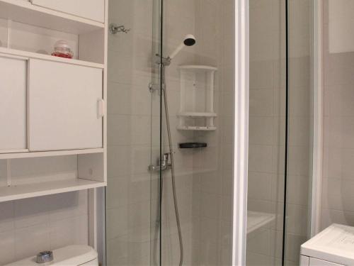 a bathroom with a shower with a glass door at Appartement Vars, 1 pièce, 3 personnes - FR-1-330B-127 in Vars