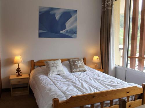 a bedroom with a bed with two pillows on it at Appartement Vars, 3 pièces, 8 personnes - FR-1-330B-141 in Vars