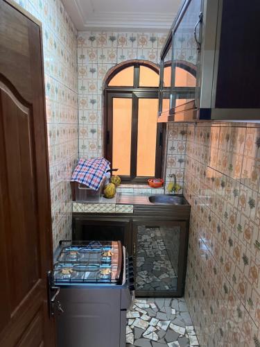 a small kitchen with a counter and a sink at Ouedraogo Property Management in Ouagadougou