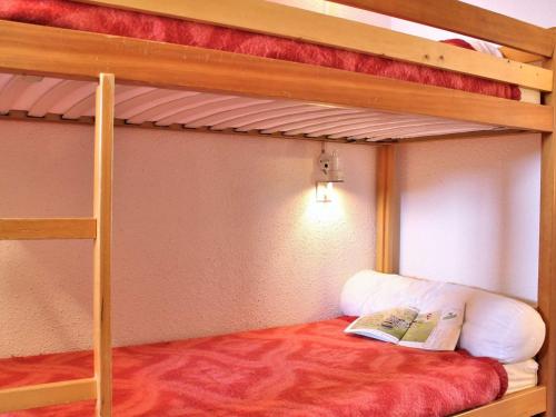 a bedroom with two bunk beds with a book at Appartement Risoul, 2 pièces, 6 personnes - FR-1-330-495 in Risoul