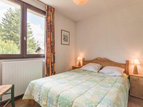 ein Schlafzimmer mit einem Bett und einem großen Fenster in der Unterkunft Appartement Saint-Chaffrey , 2 pièces, 5 personnes - FR-1-330E-2 in Saint-Chaffrey