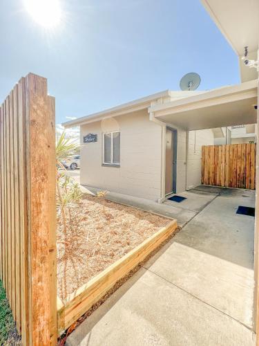 a fence in front of a house at Rockhampton Serviced Apartments in Rockhampton