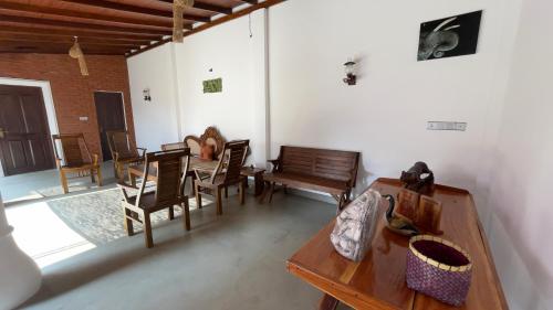 a room with chairs and a table and a table and chairs at Kathircholai in Trincomalee