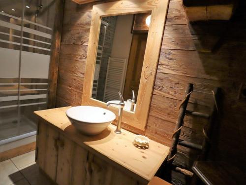 a wooden bathroom with a sink and a mirror at Chalet Arêches-Beaufort, 4 pièces, 6 personnes - FR-1-342-158 in Beaufort