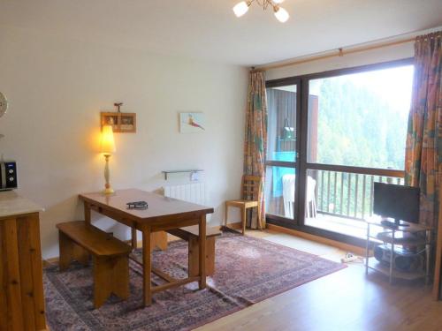 a living room with a table and a large window at Appartement Arêches-Beaufort, 3 pièces, 6 personnes - FR-1-342-152 in Arêches-Beaufort