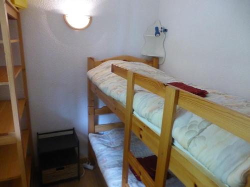 Ce lit se trouve dans un dortoir doté de 2 lits superposés et d'une lampe. dans l'établissement Charmant 3 pièces avec balcons, proche des pistes, 6 pers, navette gratuite, animaux acceptés - FR-1-342-152, à Arêches