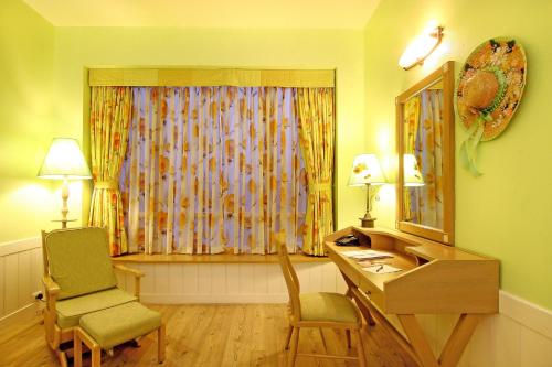 a room with a desk and a chair and a window at E Square The Fern, Pune in Pune