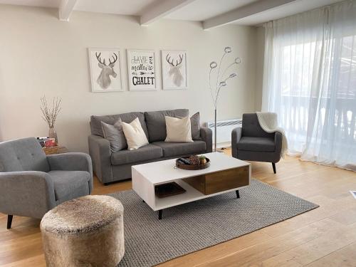 uma sala de estar com um sofá e uma mesa de centro em Mountain view fully renovated 6-8 people condo em Mont-Tremblant