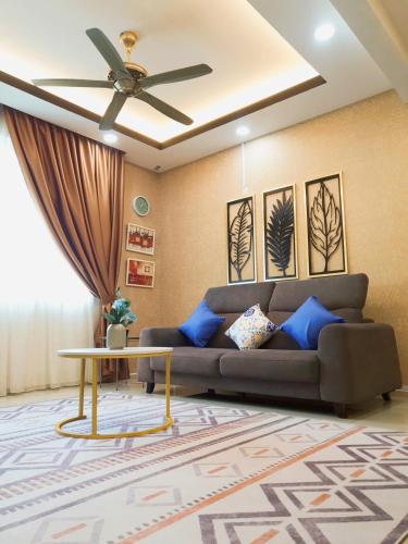 a living room with a couch and a ceiling fan at KLIA Nilai Sepang EHSAN RESIDENCE 8 PAX Air-Con Homestay in Sepang
