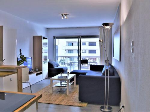 a living room with a couch and a table at Appartement Le Lavandou, 1 pièce, 3 personnes - FR-1-251-303 in Le Lavandou