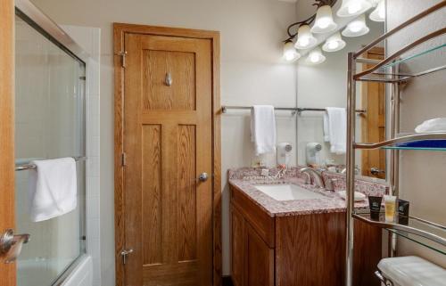 La salle de bains est pourvue d'un lavabo, d'une douche et d'un miroir. dans l'établissement River Mountain Lodge 203W, à Breckenridge