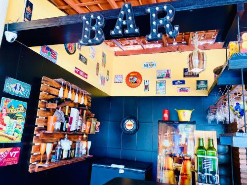 a restaurant with a counter and a shelf of food at Villa Paradise in Brazil - Praia de Guaratiba Prado-BA in Prado