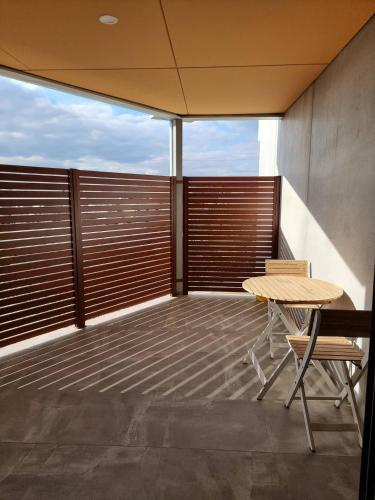 a balcony with a table and chairs on it at Waverley apartment D-one bedroom wifi available in Perth