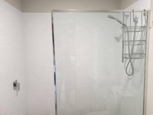 a shower with a glass door in a bathroom at Waverley apartment E-one bedroom wifi available in Perth
