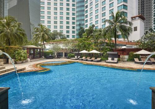 a large swimming pool in the middle of a city at AYANA Midplaza JAKARTA in Jakarta