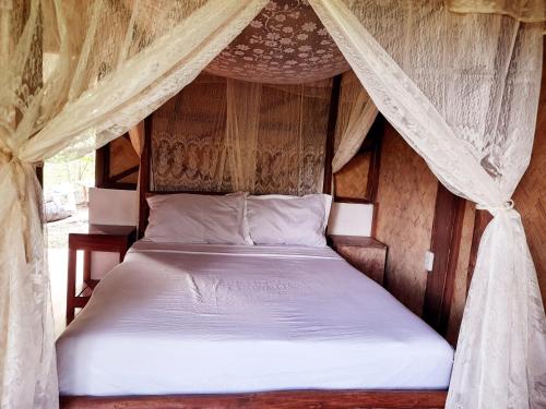 a bedroom with a bed in a tent at Erlittop Garden Eco Lodge in El Nido