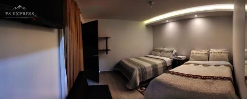 a small room with two beds in it at HOTEL UNICO in Pasto