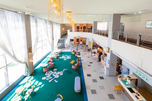 an overhead view of a school cafeteria with a play floor at Kyukamura Shikanoshima in Fukuoka