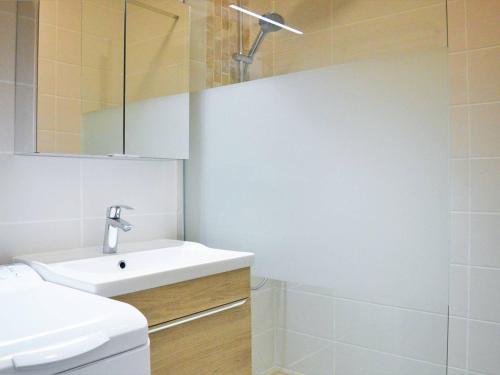 a white bathroom with a sink and a toilet at Le Lavandou : T2 avec 4 couchages, terrasse, parking en option, animaux admis - FR-1-251-212 in Le Lavandou