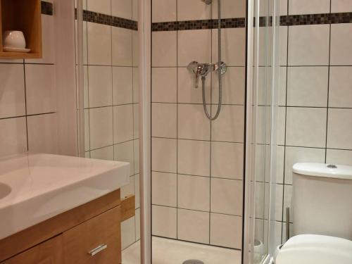 a bathroom with a shower with a toilet and a sink at Appartement Méribel, 1 pièce, 4 personnes - FR-1-180-372 in Les Allues