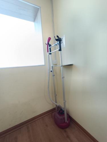a vacuum in the corner of a room with a window at Greencity Hotel in Sungai Petani