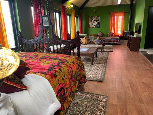 a living room with two beds and a couch at Habba Kadal Kashmiri Heritage Hotel & Hub in Coonoor