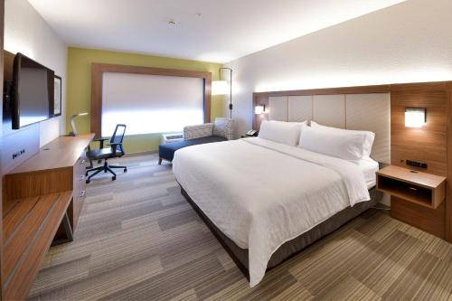 a hotel room with a large bed and a television at Holiday Inn Express & Suites - Millersburg, an IHG Hotel in Millersburg
