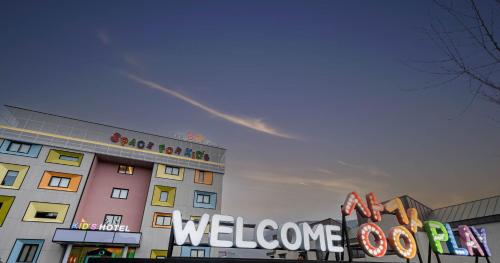 a building with a welcome sign in front of it at Kids Hotel Sangsang Play in Ulsan