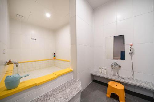 a bathroom with a sink and a shower in it at Kids Hotel Sangsang Play in Ulsan