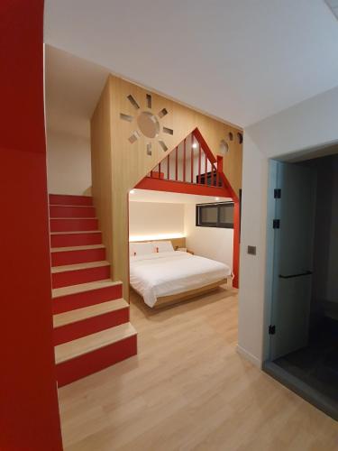 a bedroom with a staircase leading up to a bed at Kids Hotel Sangsang Play in Ulsan