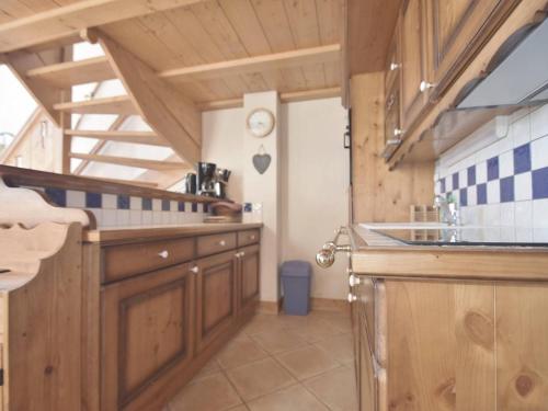 a kitchen with wooden cabinets and a sink at Appartement Le Grand-Bornand, 4 pièces, 8 personnes - FR-1-391-3 in Le Grand-Bornand