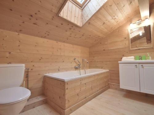 a wooden bathroom with a tub and a toilet at Chalet Le Grand-Bornand, 5 pièces, 15 personnes - FR-1-391-24 in Le Grand-Bornand