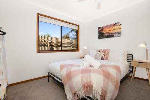 a bedroom with two beds and a window at Callala Calm Pet Friendly 5 Mins Walk to Beach in Callala Bay