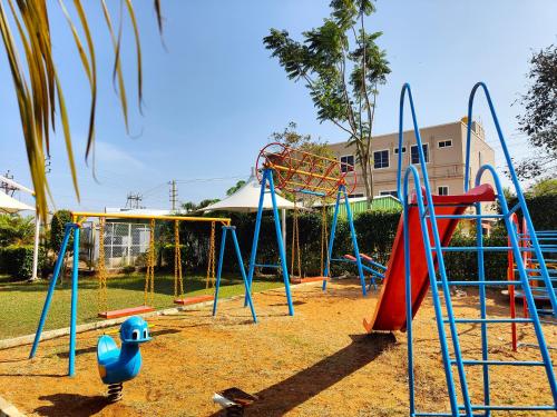 a playground with a slide and a swing set at Bandipur Wildlife Resort & Spa, Bandipur in Bandipūr